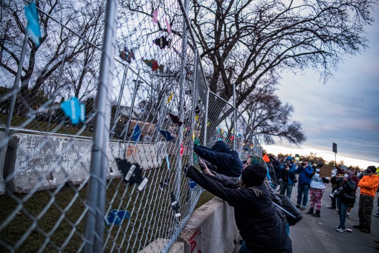 Demonstrators attempt to cut through perimeter fence and hurl objects at officers in another night of Brooklyn Center unrest