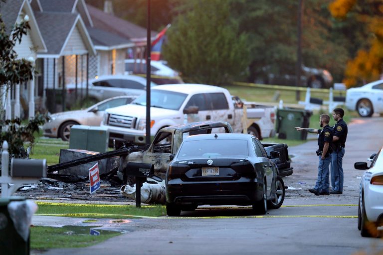Hattiesburg police surround a burned automobile and a damaged home after a small plane crashed late Tuesday night in Hattiesburg, Miss.,  Wednesday May 5, 2021. (Chuck Cook /The Advocate via AP)