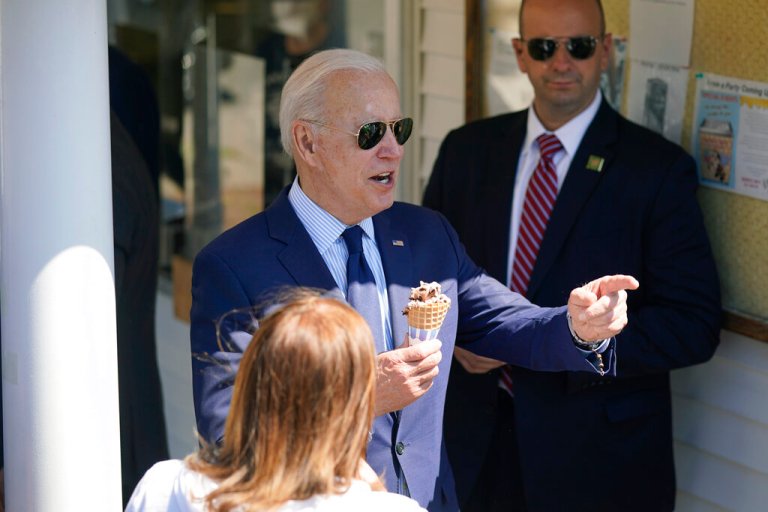 President Joe Biden talks with people as he an ice cream cone at Honey Hut Ice Cream, Thursday, May 27, 2021, in Cleveland.