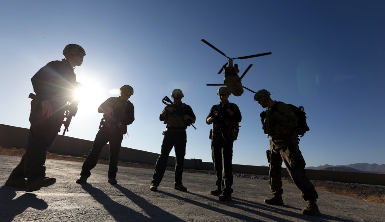 In this Nov. 30, 2017, file photo, American soldiers wait on the tarmac in Logar province, Afghanistan.