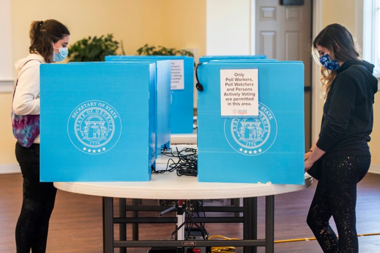 Federal judge halts effort to block portions of Georgia voting law