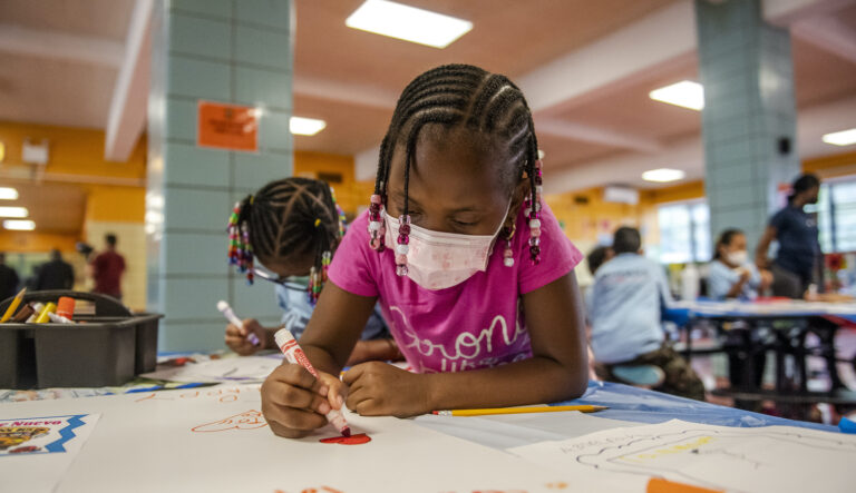 Liliana Lambert, 6,  writes down and draws positive affirmations on poster board at P.S. 5 Port Morris, a Bronx elementary school, Tuesday, Aug. 17, 2021 in New York.