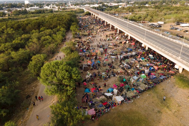 Migrants, many from Haiti, are seen at an encampment along the Del Rio International Bridge near the Rio Grande, on Sept. 21, 2021, in Del Rio, Texas.  