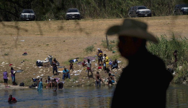 Migrants, many from Haiti, wade across the Rio Grande from Del Rio, Texas, to return to Ciudad Acuna, Wednesday, Sept. 22, 2021, some to avoid possible deportation from the U.S. and others to get supplies.