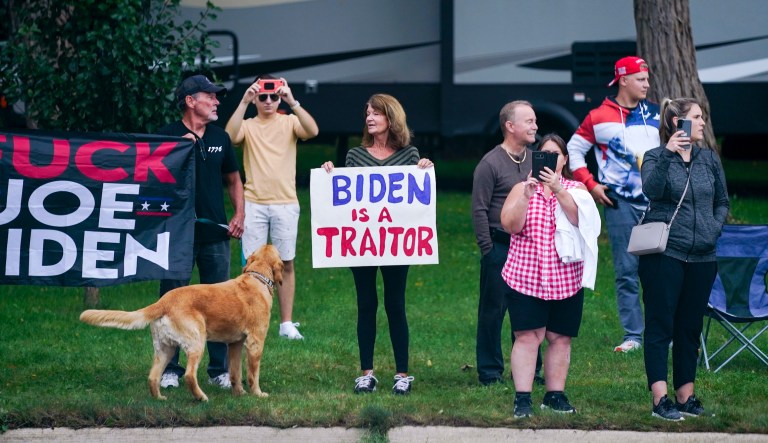 People protest as the motorcade for President Joe Biden passes by Tuesday, Oct. 5, 2021, in Howell, Mich.                                                                                                                                                                                                                                           