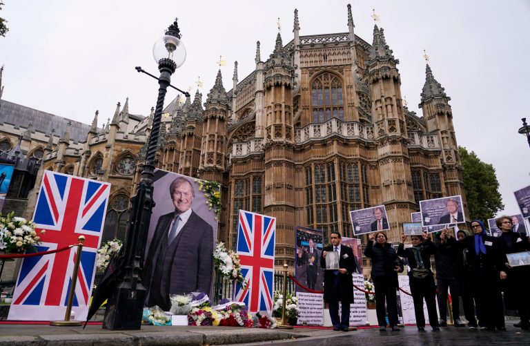 Members of the Anglo-Iranian communities and supporters of the National Council of Resistance of Iran hold a memorial service for British member of Parliament David Amess outside the Houses of Parliament in London on Oct. 18. 