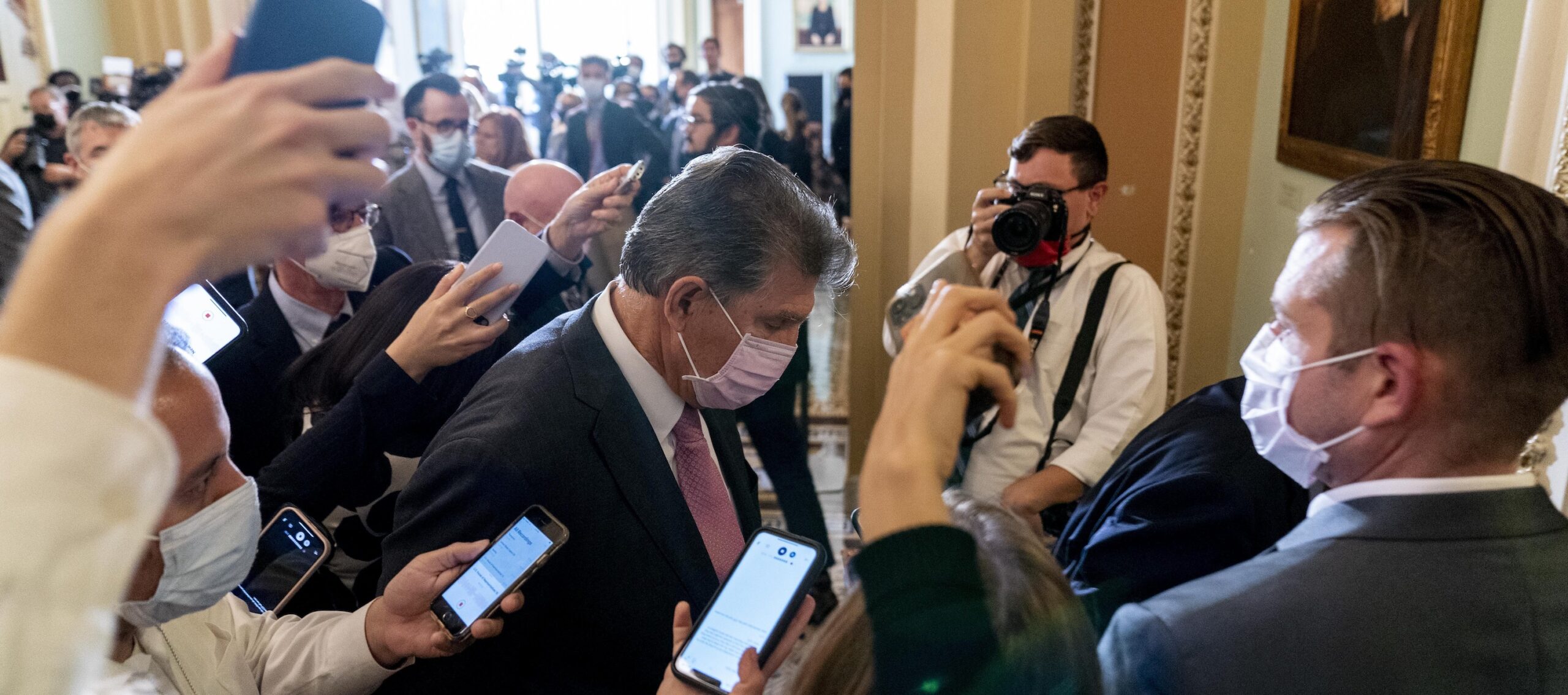 Exchange between Manchin and Sanders gets tense in closed-door meeting on spending bill
