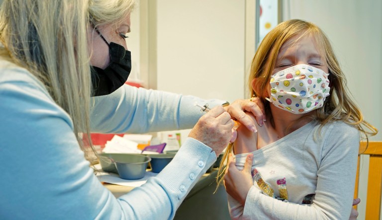 Shauna Andrus, left, a nurse volunteering at the University of Washington Medical Center, gives the first shot of the Pfizer COVID-19 vaccine to Emmy Slonecker, 7, Tuesday, Nov. 9, 2021, in Seattle. Last week, U.S. health officials gave the final signoff to Pfizer's kid-size COVID-19 shot, a milestone that opened a major expansion of the nation's vaccination campaign to children as young as 5.