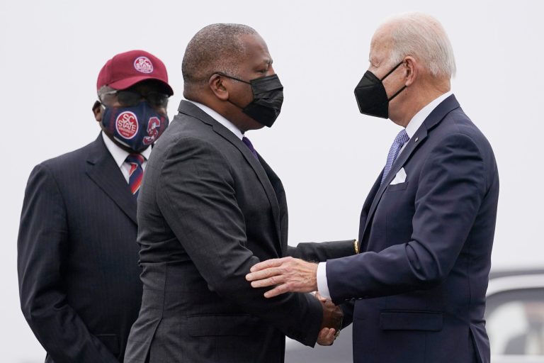 President Joe Biden is greeted by Columbia Mayor Stephen Benjamin.