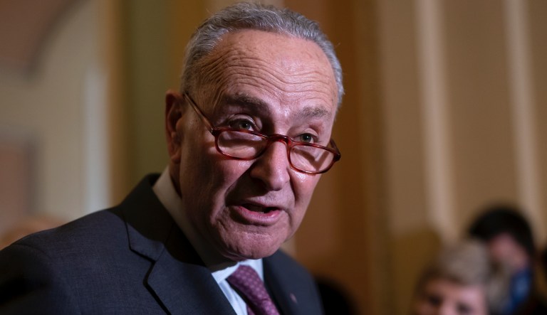 Senate Majority Leader Chuck Schumer, D-N.Y., talks to reporters about his efforts to advance their expansive social and environment bill, following a Democratic policy meeting at the Capitol in Washington, Tuesday, Dec. 14, 2021.