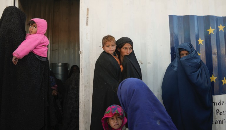 Afghan women gather outside a makeshift clinic organised by World Vision at an IDP settlement near Herat, Afghanistan, Thursday, Dec. 16, 2021.
