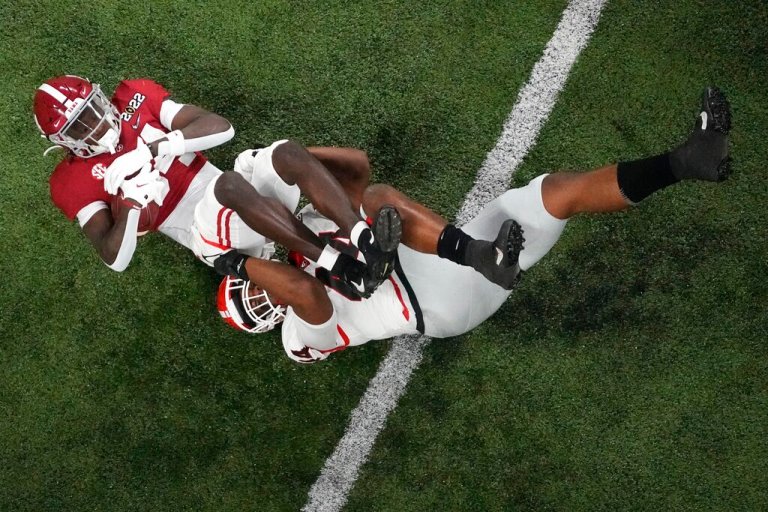 Georgia's Nolan Smith stops Alabama's Agiye Hall during the first half of the College Football Playoff championship football game Monday, Jan. 10, 2022, in Indianapolis. 
