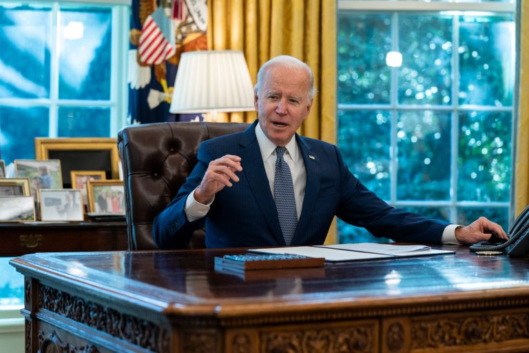 FILE - President Joe Biden speaks before signing an executive order to improve government services, in the Oval Office of the White House, Dec. 13, 2021, in Washington. Bidenâs long arc in public life has always had one final ambition: to sit behind the Resolute Desk of the Oval Office. He achieved it, albeit at 78 the oldest person to assume the presidency.