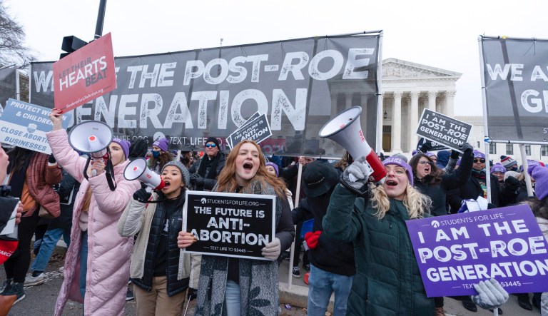 Anti-abortion activists march outside of the U.S. Supreme Court during the 