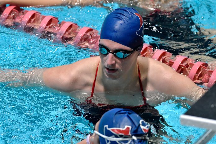 Transgender swimmer Lia Thomas, center with teammates during Warm up laps before a meet with Harvard on Saturday, Jan. 22, 2022, at Harvard University in Cambridge, Mass. 