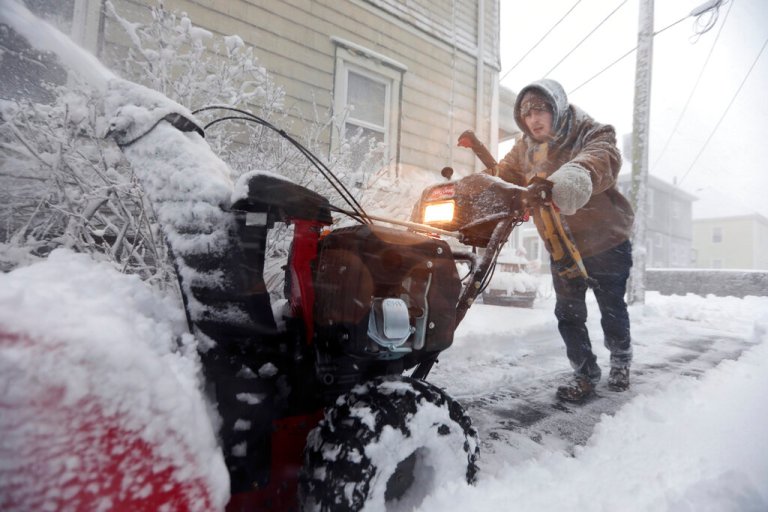 Patrick Lawrence clears his driveway of snow at his home in New Bedford, Mass., on Saturday, Jan. 29, 2022.