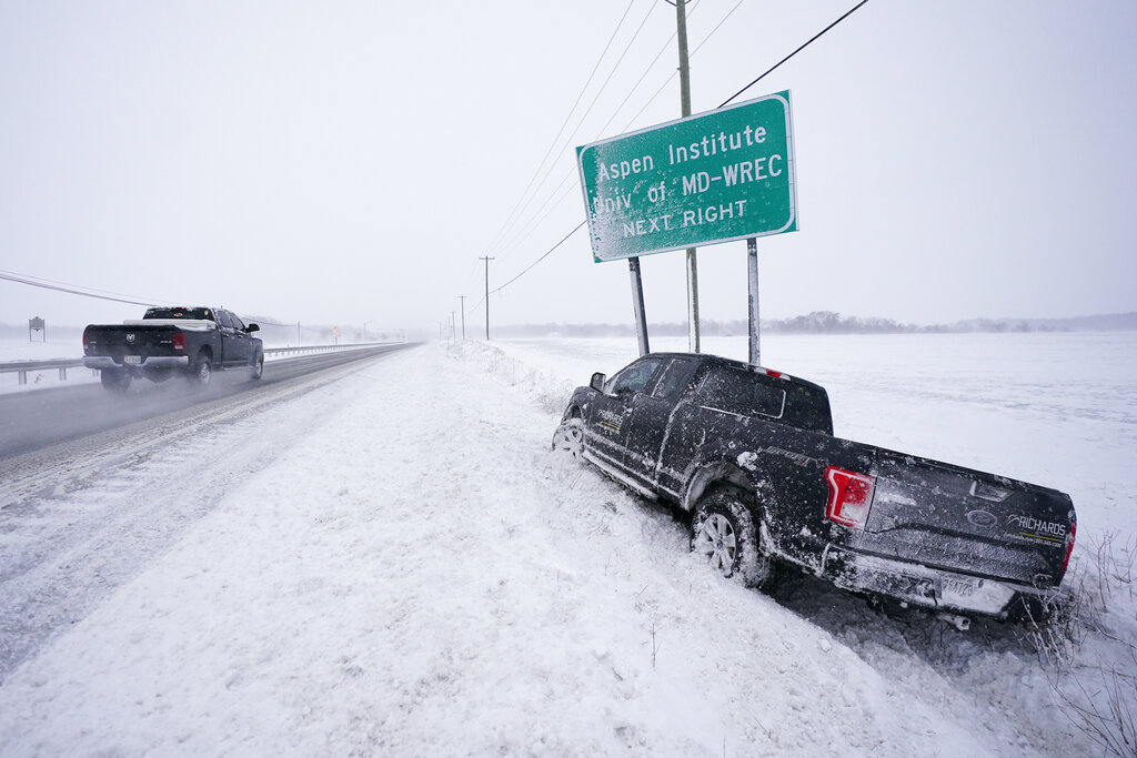 An abandoned vehicle is seen along Highway 50 during a snowstorm Saturday in Queenstown, Maryland.