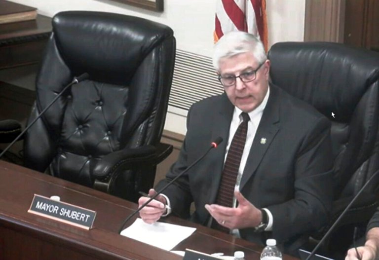This image from video shows Hudson Mayor Craig Shubert in a City Council meeting, Feb. 8, 2022 in Hudson, Ohio. Shubert, who had suggested allowing ice fishing shanties on a lake could lead to prostitution, has resigned after a week of being mocked and drawing national attention to the city. Hudson Mayor Shubert said he was stepping down Monday, Feb. 14, 2022.