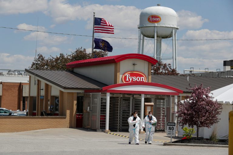 FILE - In this May 7, 2020 file photo, workers leave the Tyson Foods pork processing plant in Logansport, Indiana. (AP Photo/Michael Conroy, File)