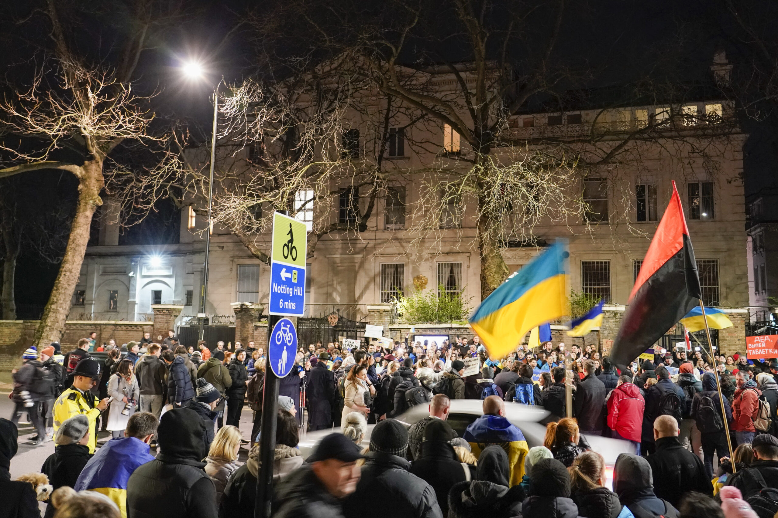 Demonstrators hold placards and flags as they attend a protest outside the Russian Embassy in London on Wednesday. Ukraine urged its citizens to leave Russia as Europe braced for further confrontation Wednesday after Russia's leader received authorization to use military force outside his country and the West responded with a raft of sanctions.