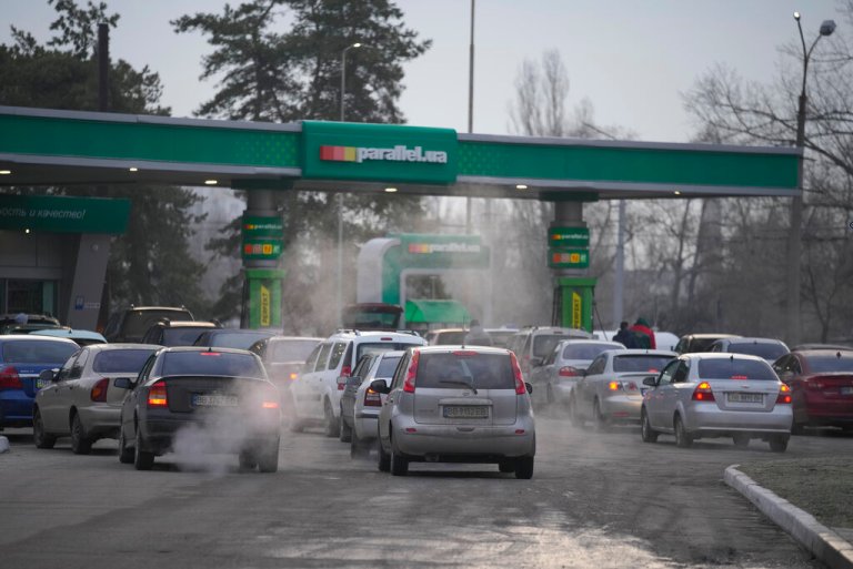 People queue for fuel at a gas station in Sievierodonetsk in the Luhansk region of eastern Ukraine on Thursday. Russian President Vladimir Putin announced a military operation in Ukraine on Thursday and warned other countries that any attempt to interfere would lead to 