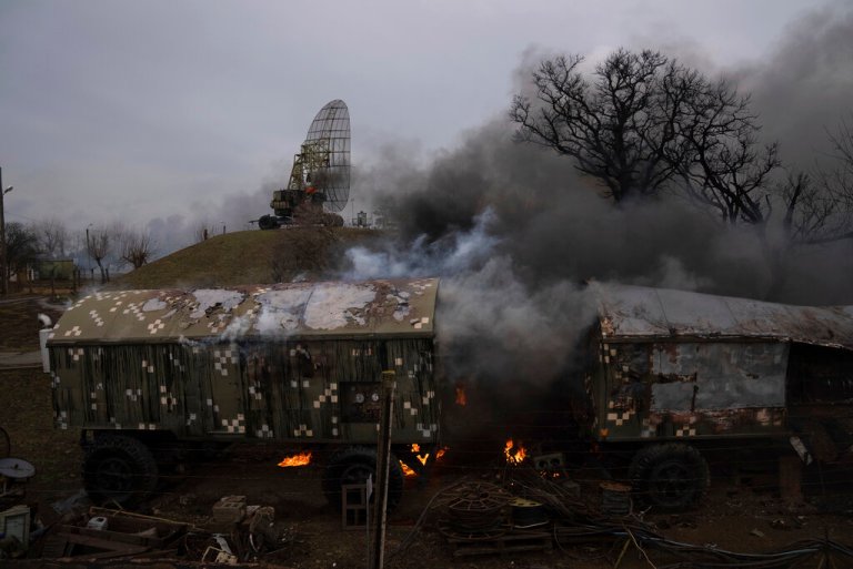 Smoke rises from an air defense base in the aftermath of an apparent Russian strike in Mariupol, Ukraine, Feb. 24, 2022.