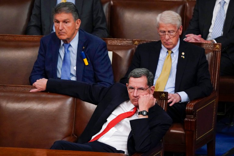 Sen. Joe Manchin, D-W.Va., left, Sen. Roger Wicker, R-Miss., right, and Sen. John Barrasso, R-Wyo., listen as President Joe Biden delivers his first State of the Union address to a joint session of Congress, at the Capitol in Washington, Tuesday, March 1, 2022. 
