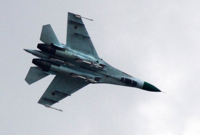Ukrainian air force Su-27 fighter jet is in the sky.