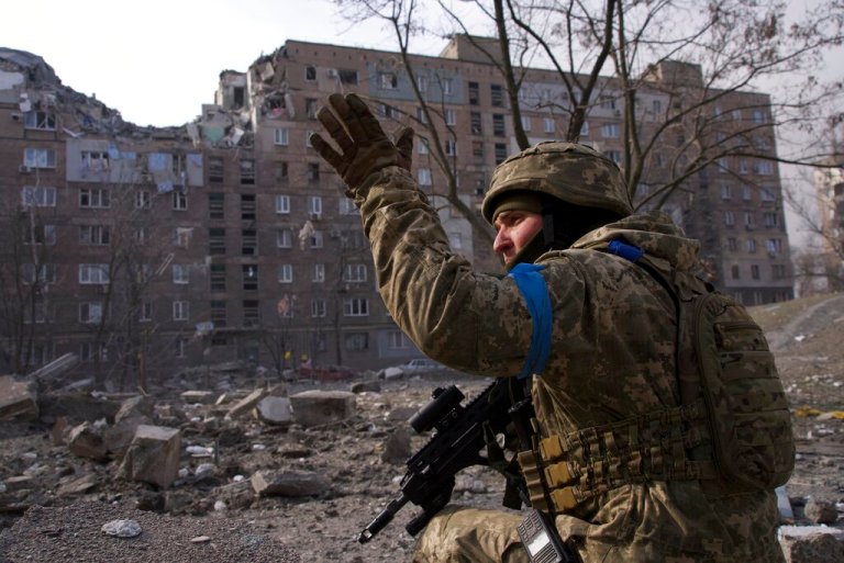 A Ukrainian serviceman guards his position in Mariupol, Ukraine, Saturday, March 12, 2022. The Ukrainian military says Russian forces have captured the eastern outskirts of the besieged city of Mariupol. In a Facebook update Saturday, the military said the capture of Mariupol and Severodonetsk in the east was a priority for Russian forces. Mariupol has been under siege for over a week, with no electricity, gas, or water. 