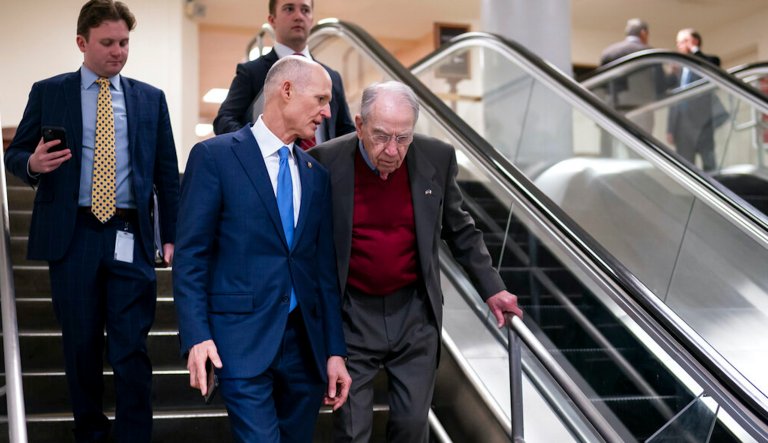 Sen. Rick Scott, a Florida, left, and Sen. Chuck Grassley, an Iowa Republican, arrive as senators gather for a briefing on the war in Ukraine, in Washington, Wednesday, March 30, 2022.