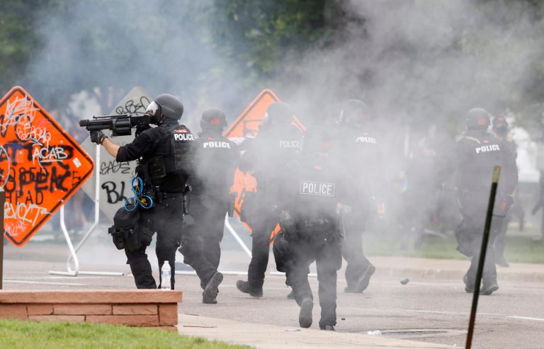 Denver Police fire tear gas canisters during a protest outside the State Capitol over the death of George Floyd in this file photograph taken Saturday, May 30, 2020, in Denver. A federal juryâs $14 million award to Denver protesters injured during 2020 demonstrations over the killing of George Floyd could resonate nationwide as courts weigh more than two dozen similar lawsuits.