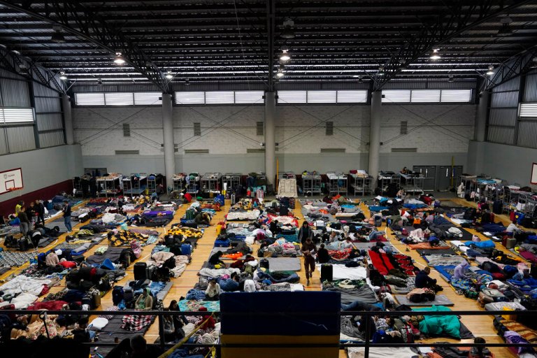 Ukrainian refugees wait in a gymnasium on April 5, 2022, in Tijuana, Mexico. Hundreds of Ukrainian refugees are arriving daily to this Mexican border city, where they wait two to four days for U.S officials to admit them on humanitarian parole. 