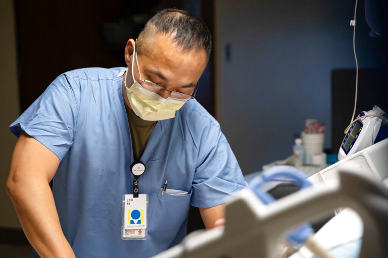 In this image provided by the U.S. Navy, Army Sgt. Young Lee, a licensed practical nurse assigned to the 29th Hospital Center, based out of Joint Base Lewis-McChord, Wash.