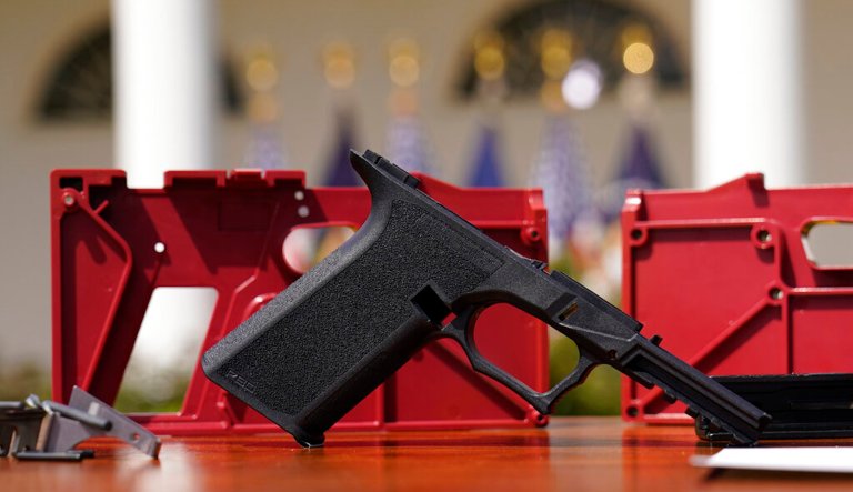 A 9mm pistol build kit with a commercial slide and barrel with a polymer frame is displayed before President Joe Biden and Deputy Attorney General Lisa Monaco speak in the Rose Garden of the White House.