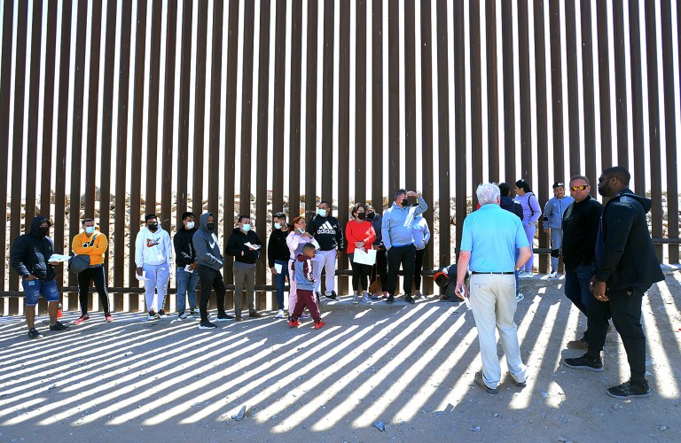 Buy these photos at YumaSun.com
United States Congressman Byron Donalds (R-Fla.) (right), Yuma County Board of Supervisors member Jonathan Lines (second from right) and U.S. Congressman Pete Sessions (R-Texas) (third from right in foreground) meet a group of undocumented immigrants Tuesday morning at the border fence between the United States and Mexico near Morelos Dam.
Photo by Randy Hoeft/Yuma Sun