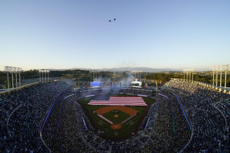 Planes fly over Dodger Stadium as the national anthem is sung before a baseball game between the Cincinnati Reds and the Los Angeles Dodgers in Los Angeles, Thursday, April 14, 2022. Stadium concession workers could go on strike in advance of next weekâs All-Star Game, the union representing those workers said Monday. (AP Photo/Ashley Landis)