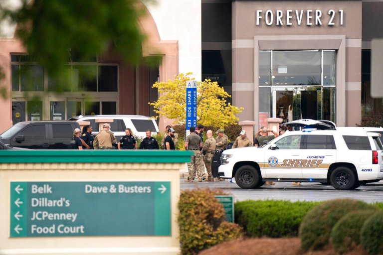 Members of law enforcement gather outside Columbiana Centre mall in Columbia, S.C., following a shooting, Saturday, April 16, 2022.
