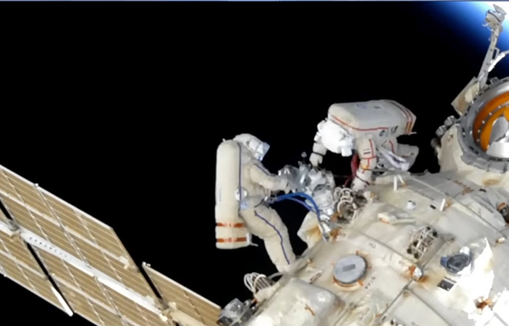 Astronauts watch as trash floats away during spacewalk
