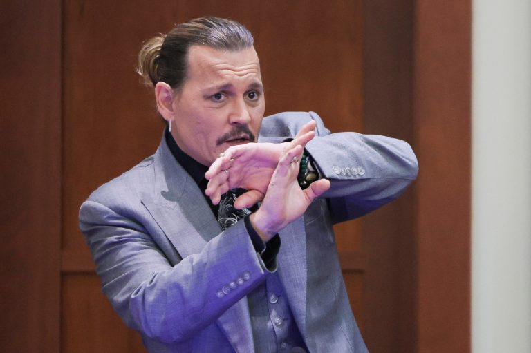 Actor Johnny Depp demonstrates how he claims to have shielded himself from an alleged attack by his ex-wife, Amber Heard.