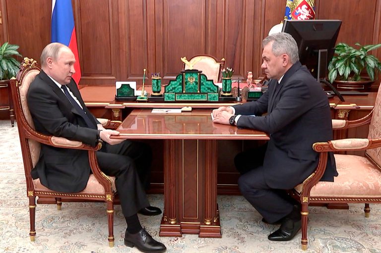 In this photo released by the Russian Presidential Press Service, Russian President Vladimir Putin, left, and Russian Defense Minister Sergei Shoigu look at each other during their meeting in the Kremlin.