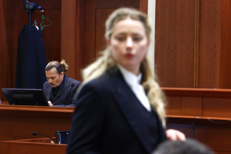 Actor Amber Heard speaks with her legal team as actor Johnny Depp returns to the stand after a lunch recess at the Fairfax County Circuit Court in Fairfax, Virginia, on Thursday.