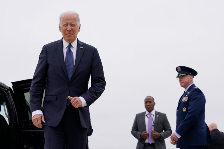 President Joe Biden walks over to speak with members of the press after stepping off Air Force One.