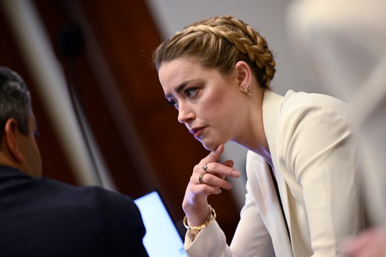 Actress Amber Heard talks to her attorney as she arrives in the courtroom at the Fairfax County Circuit Court in Fairfax, Va., Tuesday, April 26, 2022. Actor Johnny Depp sued his ex-wife actress Amber Heard for libel in Fairfax County Circuit Court after she wrote an op-ed piece in The Washington Post in 2018 referring to herself as a 