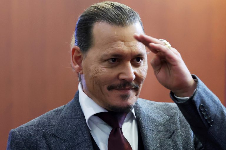 Actor Johnny Depp reacts to fans in the courtroom as court finishes for the day at the Fairfax County Circuit Court in Fairfax, Virginia.