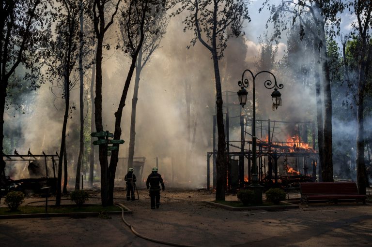 Firefighters extinguish a fire following a Russian bombardment at a park in Kharkiv, Ukraine, Tuesday, May 3, 2022. 