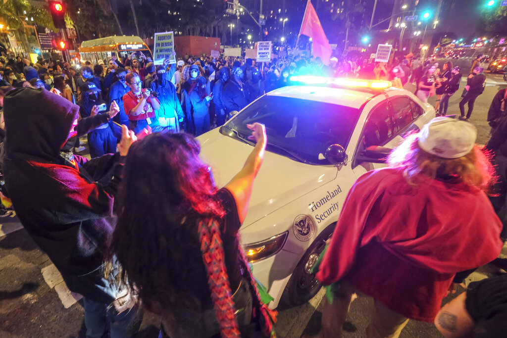 Abortion rights protesters ‘throw rocks and bottles’ at police in Los Angeles