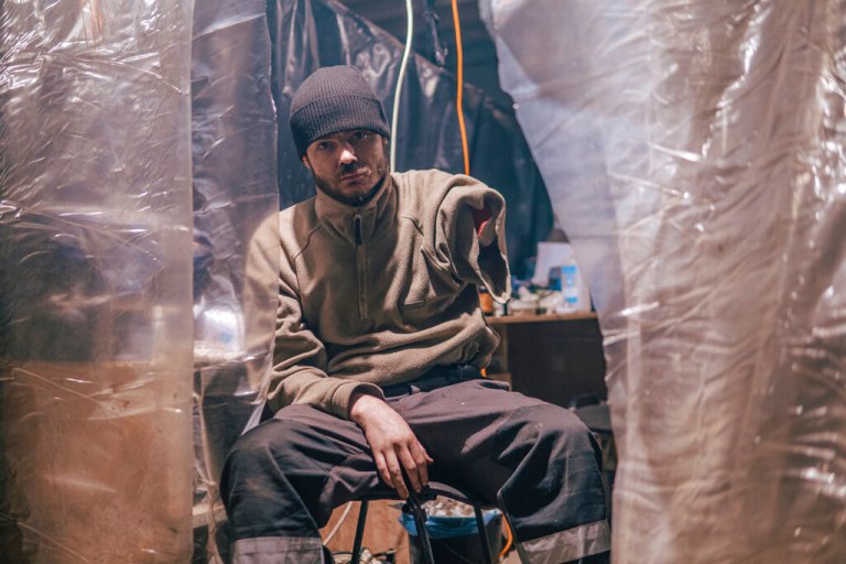 In this photo provided by Azov Special Forces Regiment of the Ukrainian National Guard Press Office, an Azov Special Forces Regiment's serviceman, injured during fighting against Russian forces, poses for a photographer inside the Azovstal steel plant in Mariupol, Ukraine, Tuesday, May 10, 2022.