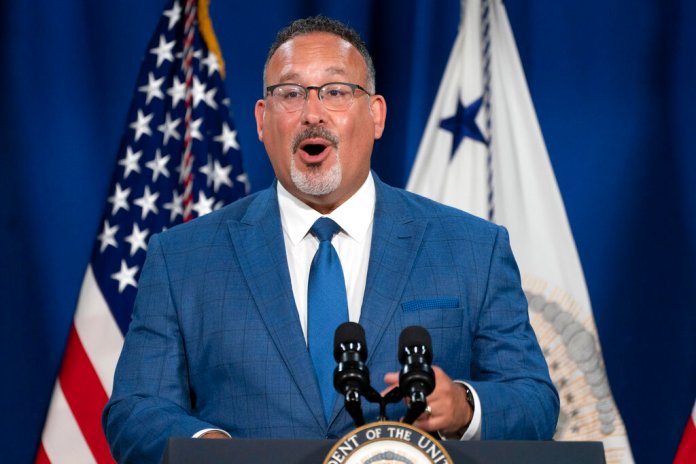 Education Secretary Miguel Cardona speaks at an event where Vice President Kamala Harris announced the cancelation of all federal student loans borrowed by students to attend any Corinthian Colleges, Thursday, June 2, 2022, at the Department of Education in Washington. The Biden Administration agreed June 23 to cancel student debt of 200K borrowers who say they were defrauded (AP Photo/Jacquelyn Martin)