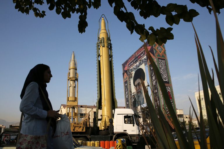 A Ghadr-H missile, center, a solid-fuel surface-to-surface Sejjil missile, and a portrait of the Supreme Leader Ayatollah Ali Khamenei are on display.