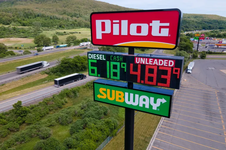 Trucks and cars drive by a Pilot Travel Center sign displaying fuel prices in Bath, New York, on Monday, June 20, 2022. The owners of a small New York farm, Lloyd Crest, had almost 800 gallons of diesel gasoline stolen from them in June. (AP Photo/Ted Shaffrey)